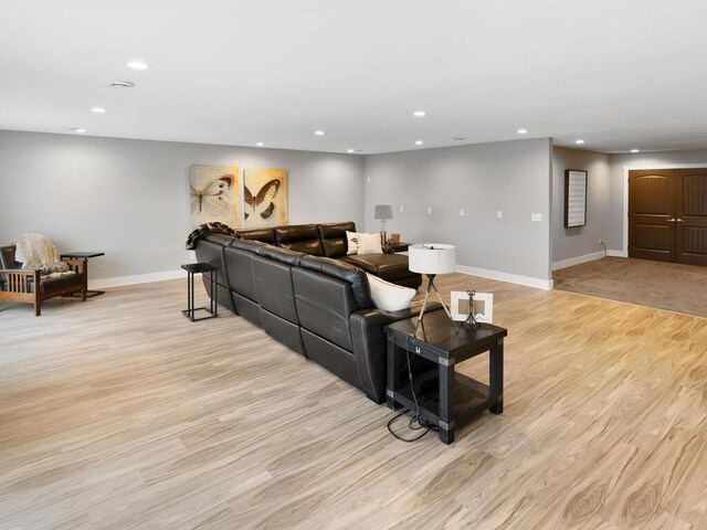 living room with baseboards, light wood-type flooring, and recessed lighting