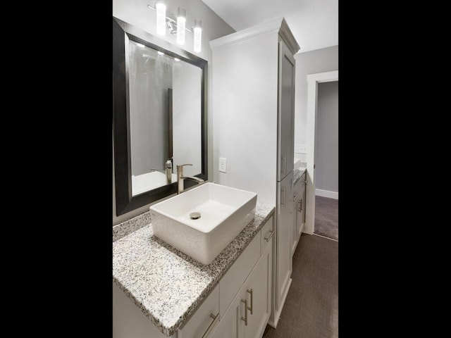 bathroom featuring vanity and baseboards