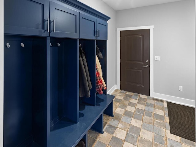 mudroom featuring visible vents, baseboards, and stone finish flooring