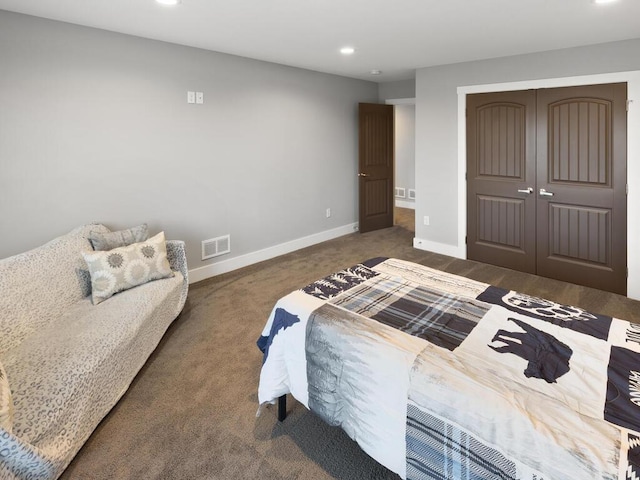 carpeted bedroom featuring a closet, recessed lighting, visible vents, and baseboards