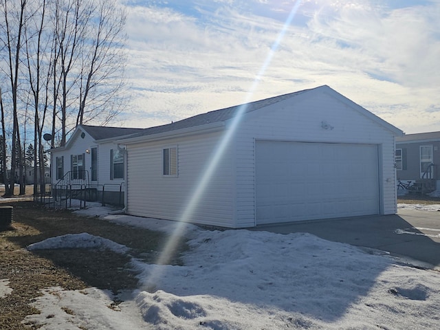 view of property exterior featuring a garage and an outdoor structure