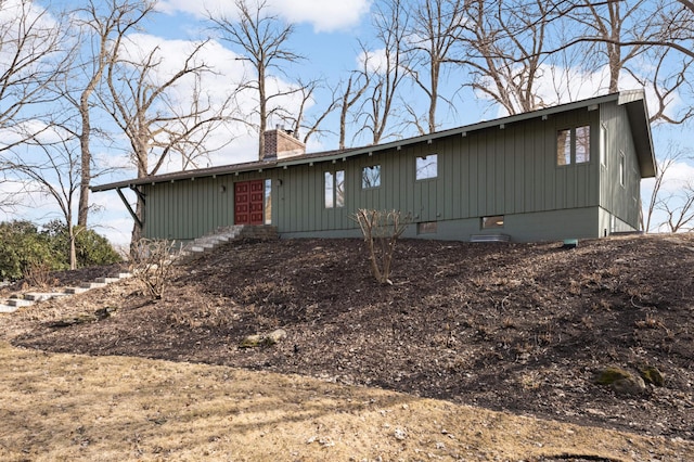 view of front of property featuring crawl space and a chimney