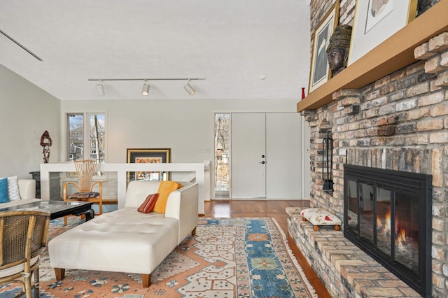 living room with a fireplace and wood finished floors