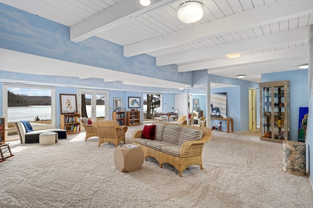 living area featuring carpet floors, french doors, and beamed ceiling