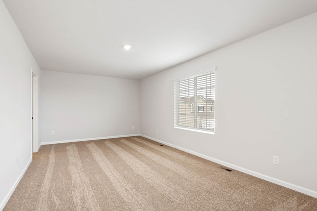 empty room with light carpet, recessed lighting, visible vents, and baseboards