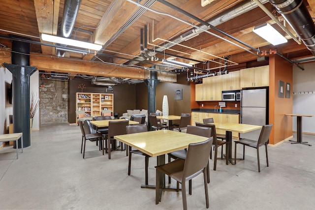 dining area featuring concrete floors