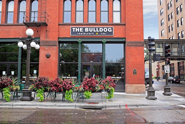 view of exterior entry featuring brick siding