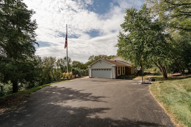 exterior space with aphalt driveway and an attached garage