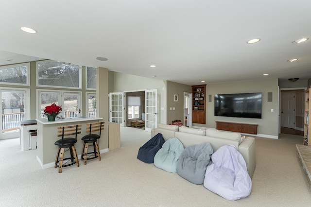 carpeted living area featuring baseboards, french doors, and recessed lighting