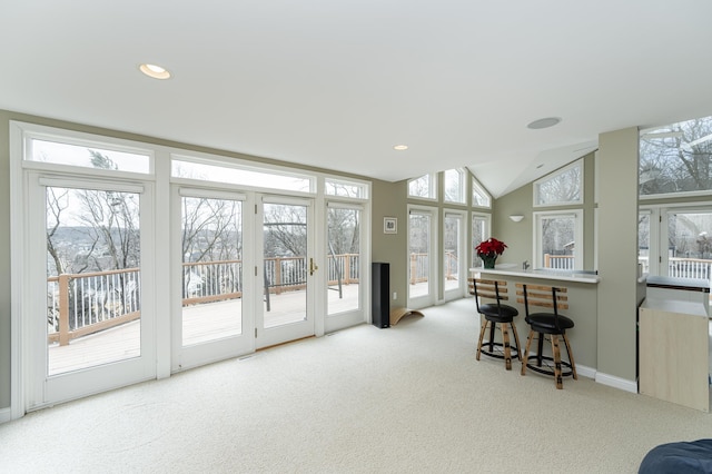 interior space featuring carpet floors, vaulted ceiling, and recessed lighting