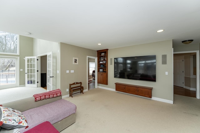 living room with carpet, baseboards, and french doors