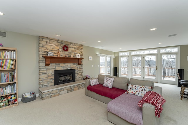 living room featuring baseboards, a fireplace, carpet flooring, and recessed lighting