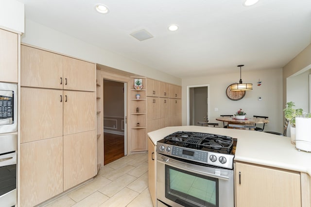 kitchen with light brown cabinets, recessed lighting, light countertops, appliances with stainless steel finishes, and decorative light fixtures