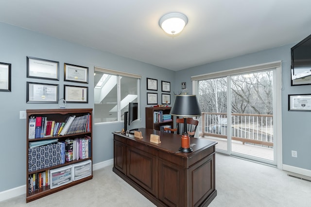 office area featuring light carpet, visible vents, and baseboards