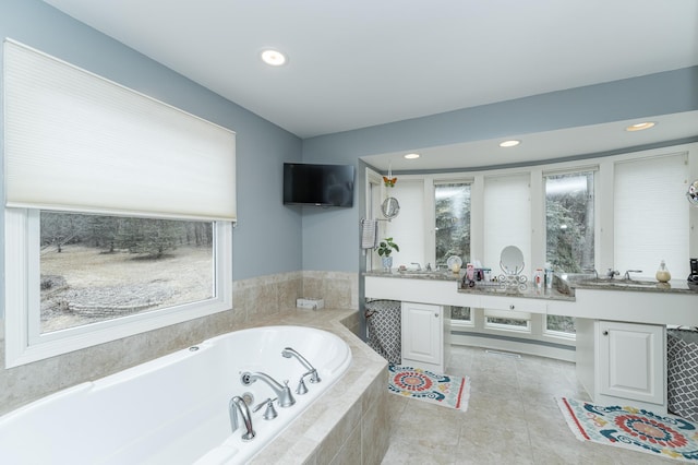 full bath featuring double vanity, a tub with jets, tile patterned flooring, and recessed lighting