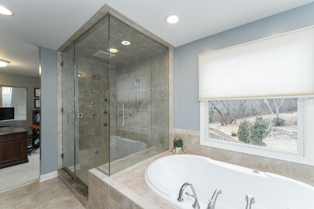 bathroom featuring a stall shower, baseboards, tile patterned floors, a bath, and recessed lighting