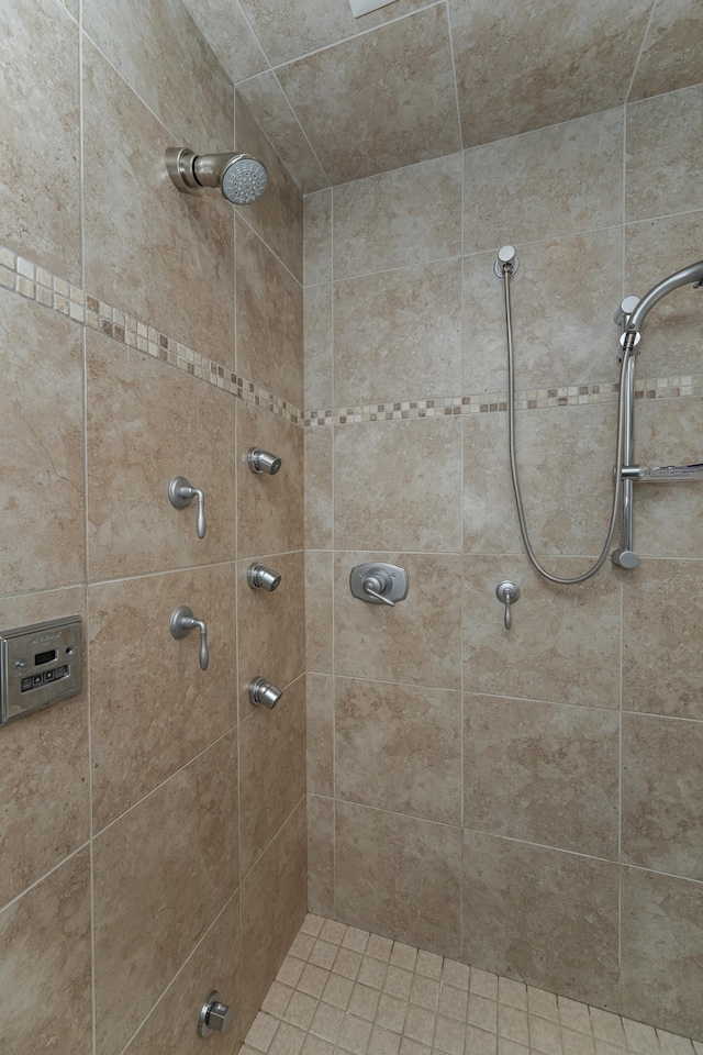 bathroom with a tile shower