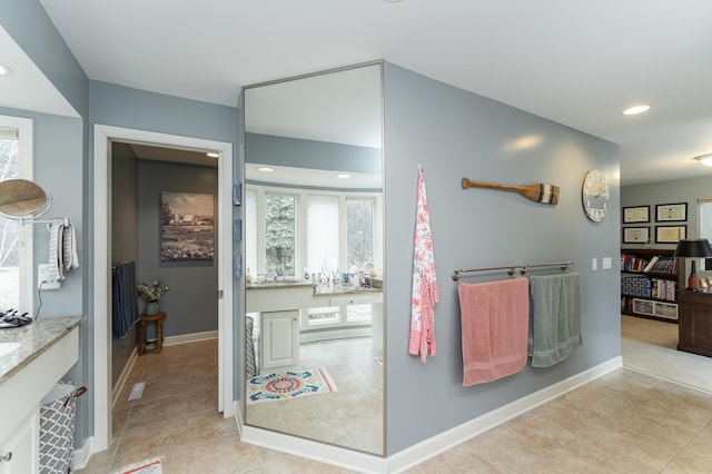 bathroom with tile patterned flooring, vanity, baseboards, and recessed lighting