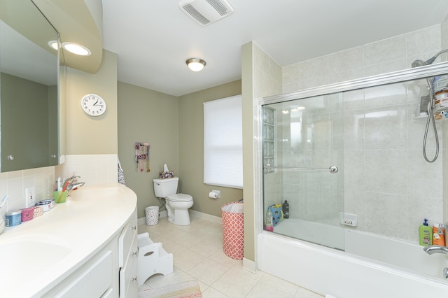 full bathroom with toilet, tile patterned flooring, visible vents, and a sink