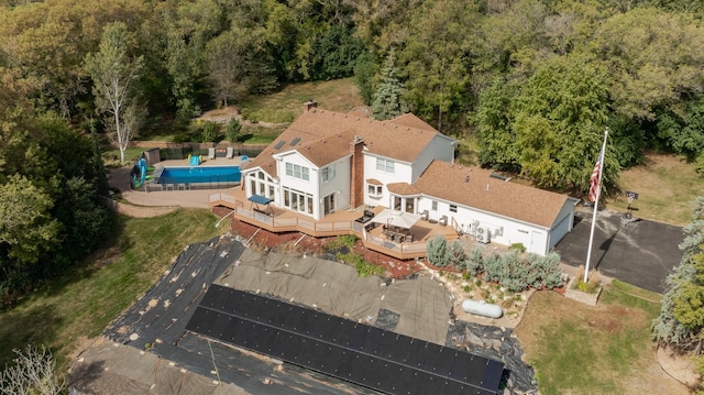 drone / aerial view with a wooded view