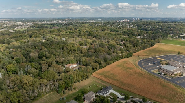 birds eye view of property featuring a view of trees