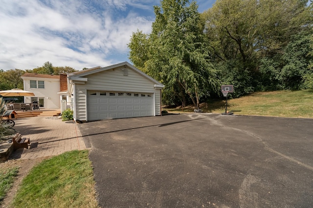 view of front of house with a garage, a front lawn, and a wooden deck