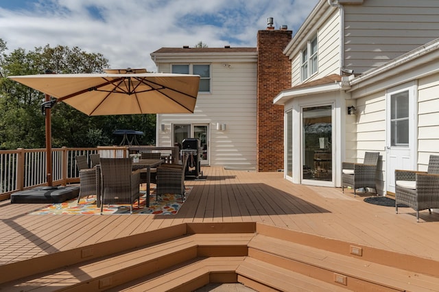 wooden terrace featuring outdoor dining area