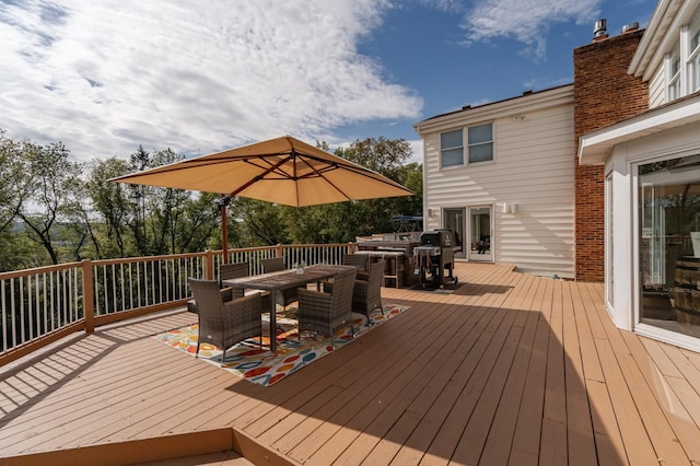 wooden terrace with outdoor dining area