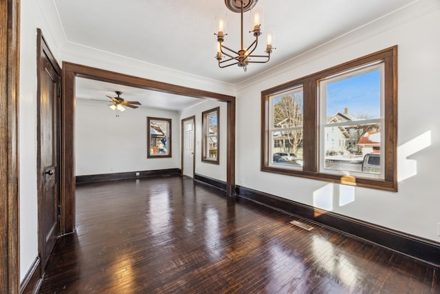 unfurnished room featuring dark wood-style floors, baseboards, a chandelier, and crown molding