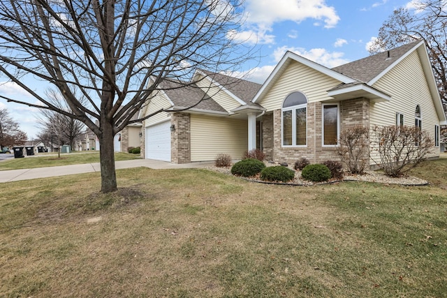 view of front of home featuring a garage, a front yard, brick siding, and driveway