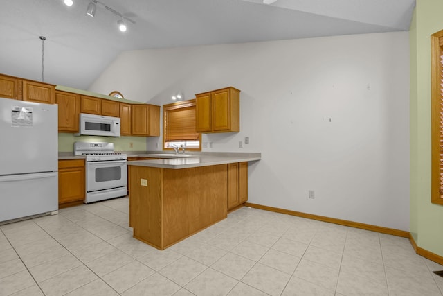 kitchen with brown cabinets, vaulted ceiling, white appliances, a peninsula, and baseboards