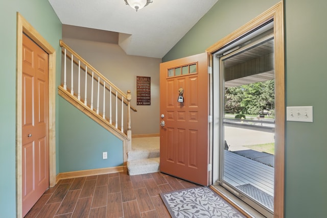 1615 Quasar Ct S, Lake Saint Croix Beach, MN 55043 - foyer entrance with stairs, lofted ceiling, dark wood-style floors, and baseboards
