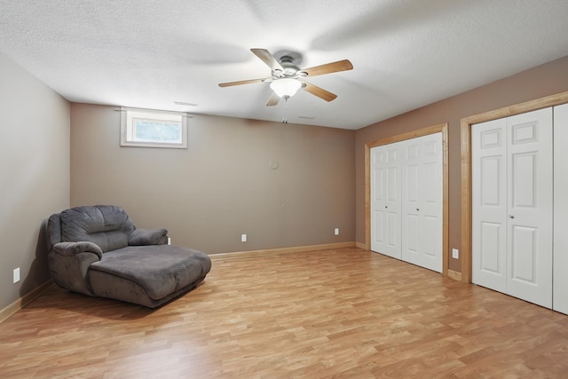 1615 Quasar Ct S, Lake Saint Croix Beach, MN 55043 - sitting room featuring light wood finished floors, a ceiling fan, a textured ceiling, and baseboards