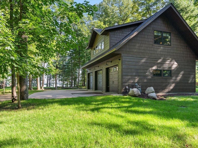 view of side of property with a garage, a lawn, and driveway