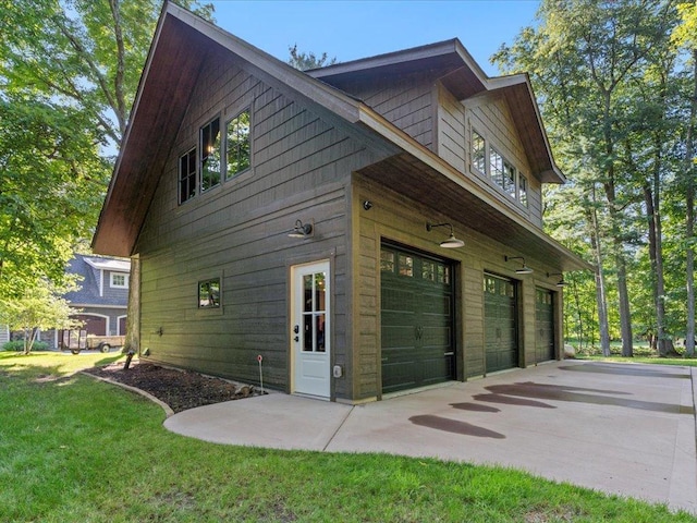 view of home's exterior featuring a lawn and an attached garage