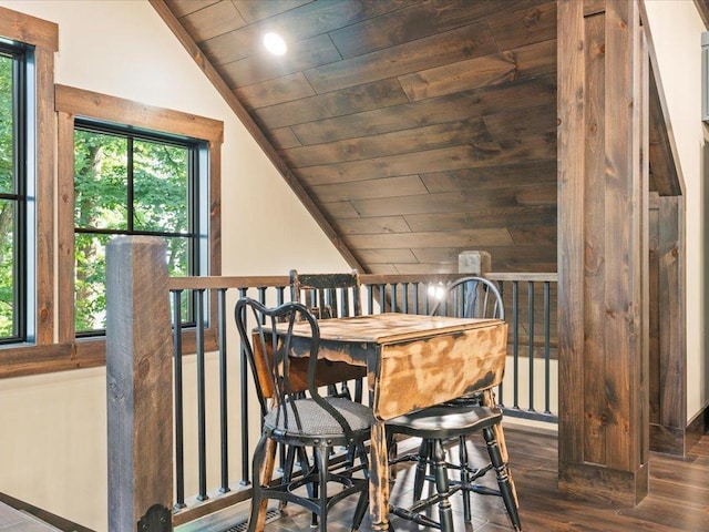 dining room featuring wooden ceiling, a healthy amount of sunlight, vaulted ceiling, and wood finished floors