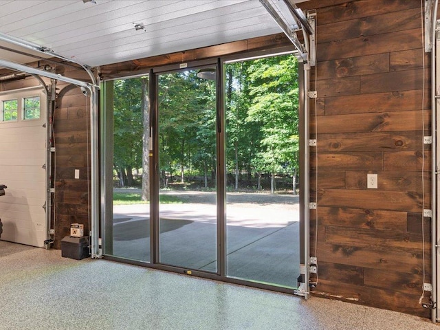 interior space with wooden walls and speckled floor