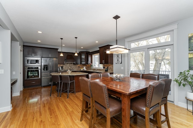 dining area with recessed lighting, baseboards, and light wood-type flooring