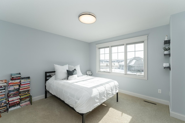 bedroom with visible vents, carpet flooring, and baseboards