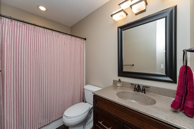 full bathroom with vanity and toilet