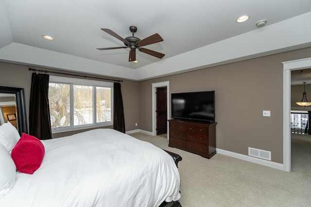 bedroom with visible vents, baseboards, a tray ceiling, carpet floors, and recessed lighting