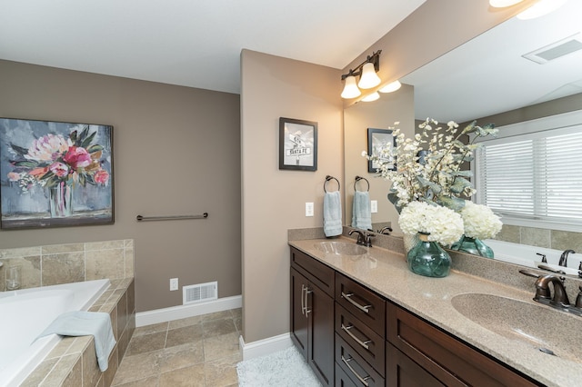 full bathroom with double vanity, visible vents, and a sink