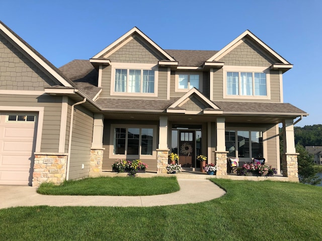 craftsman-style house with a front lawn and a shingled roof