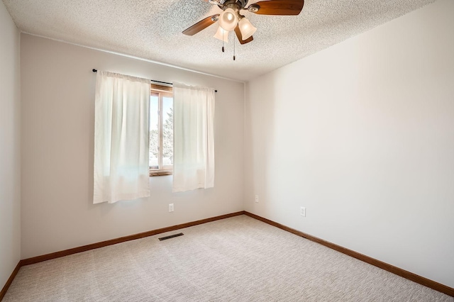 unfurnished room with baseboards, visible vents, a textured ceiling, and carpet