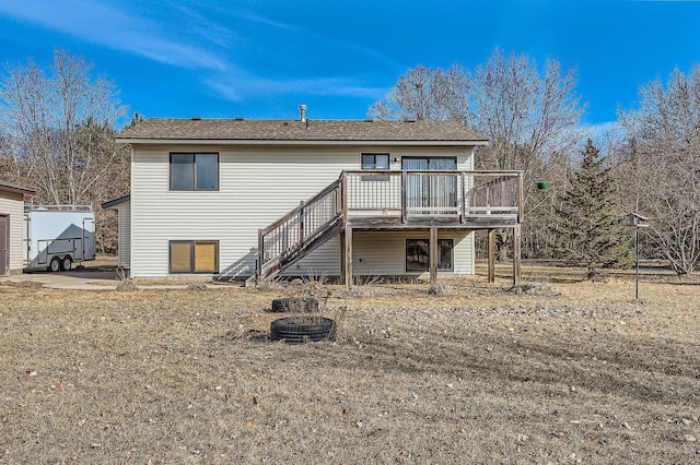 back of house featuring stairway and a wooden deck