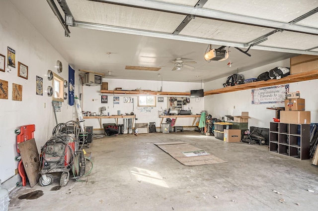 garage with a ceiling fan, a workshop area, and a garage door opener