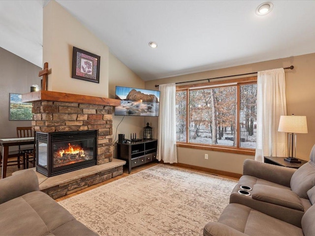 living area with wood finished floors, baseboards, lofted ceiling, recessed lighting, and a glass covered fireplace