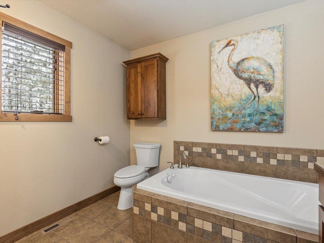 bathroom with a garden tub, visible vents, baseboards, tile patterned floors, and toilet