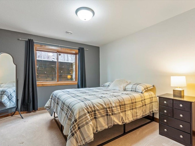 bedroom featuring light carpet