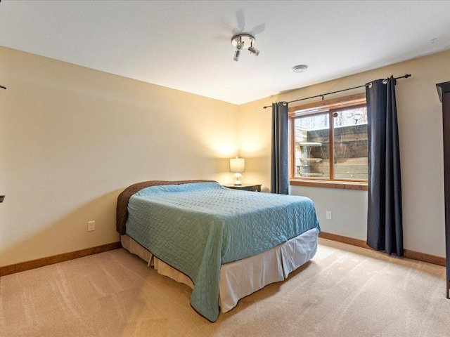 bedroom featuring baseboards and carpet floors